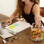Woman eating candy from a glass jar at work
