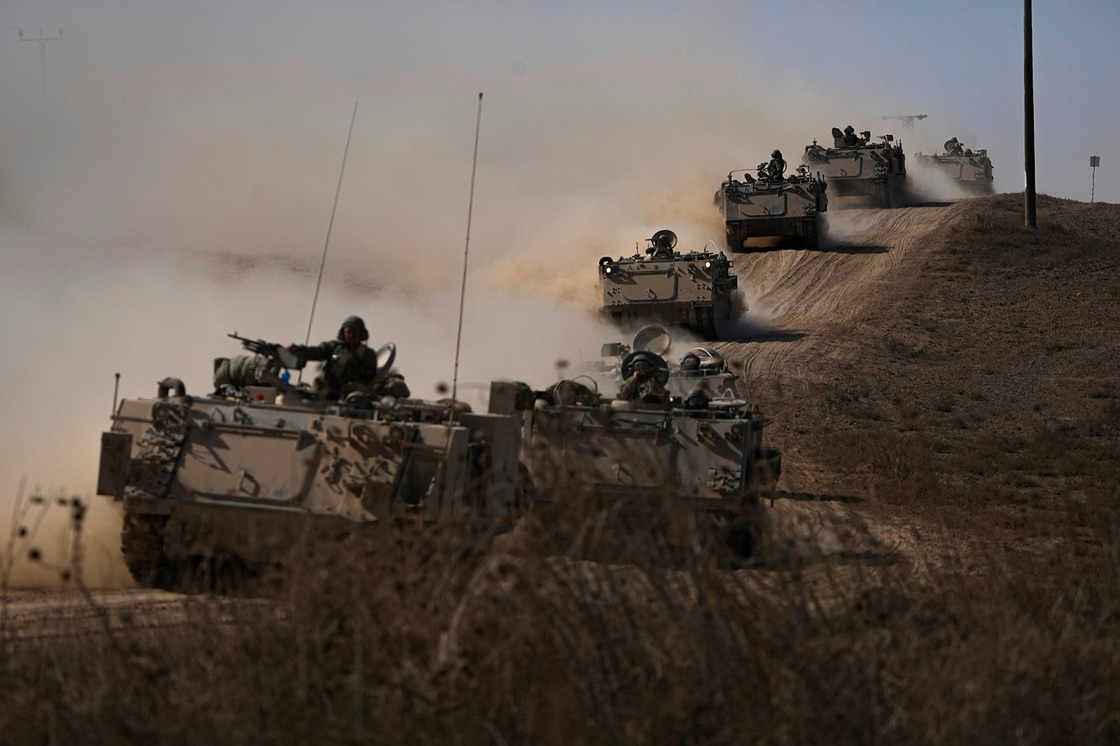 Israeli tanks and APC head toward the Gaza Strip border in Southern Israel on Friday, Oct.13, 2023. (AP Photo/Ariel Schalit)